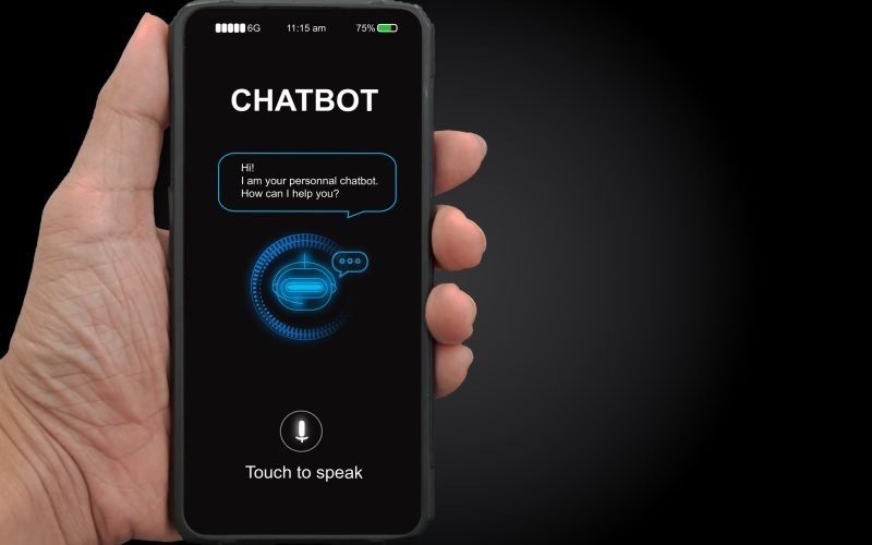 Hand holding smartphone displaying a chatbot interface with greeting message and voice activation option, emphasizing digital marketing and user engagement solutions.